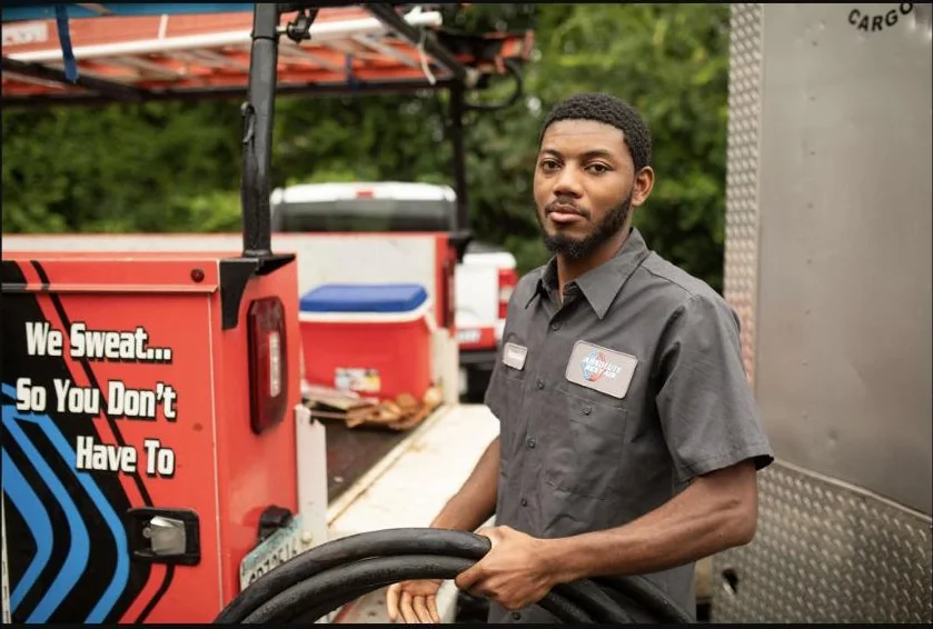 Absolute Best Air team member beside a branded service vehicle